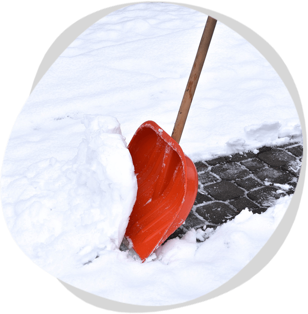 A red snow shovel is in the snow.